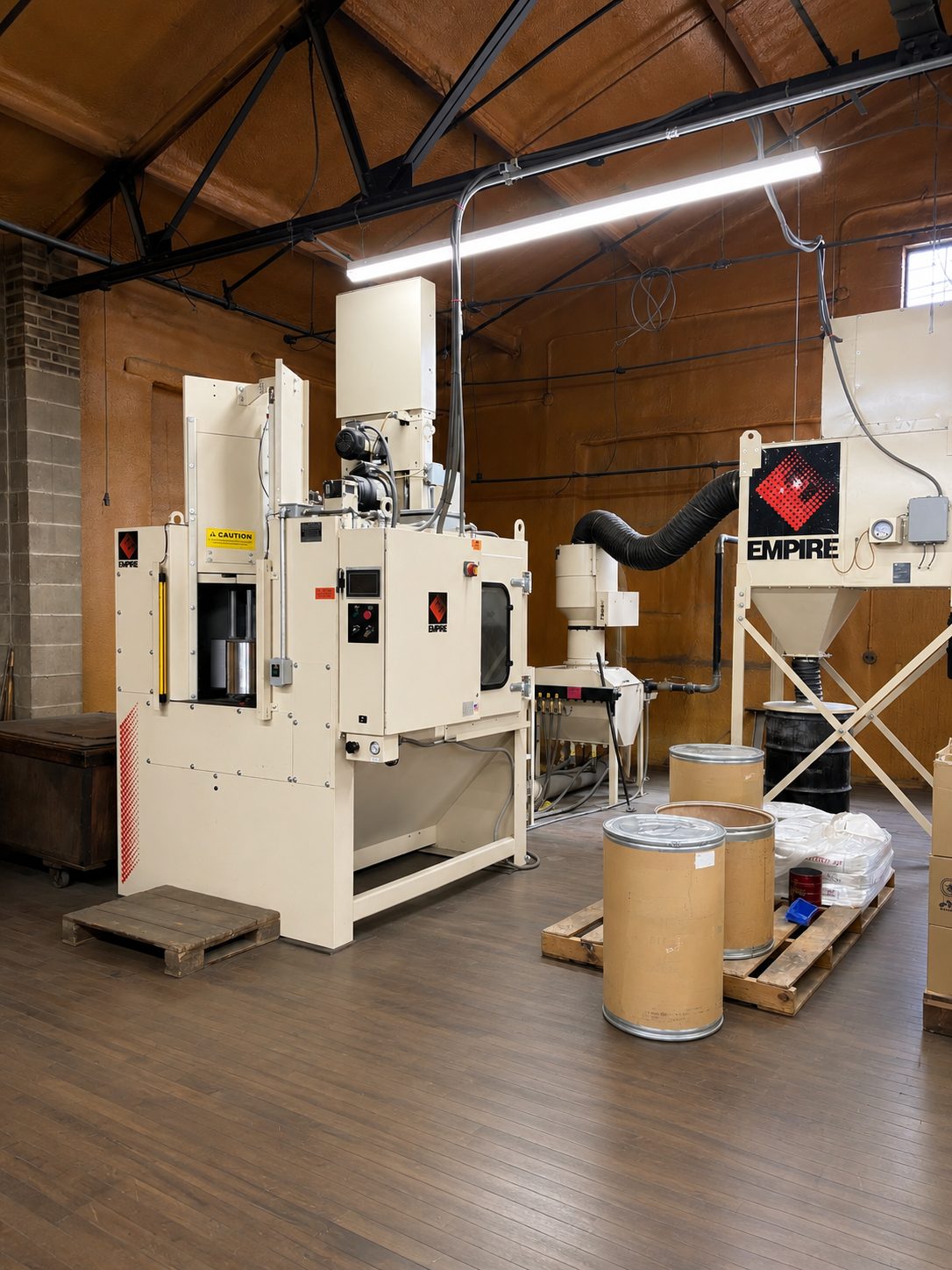 Empire automated suction blast cabinet and dust collection in the Corry Rubber metal preparation room