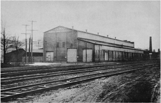 Historic photograph of the original Corry, Pennsylvania plant building alongside the rail yard